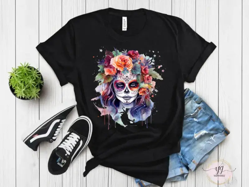 Black t-shirt featuring a colorful sugar skull design with floral elements and watercolor effects.