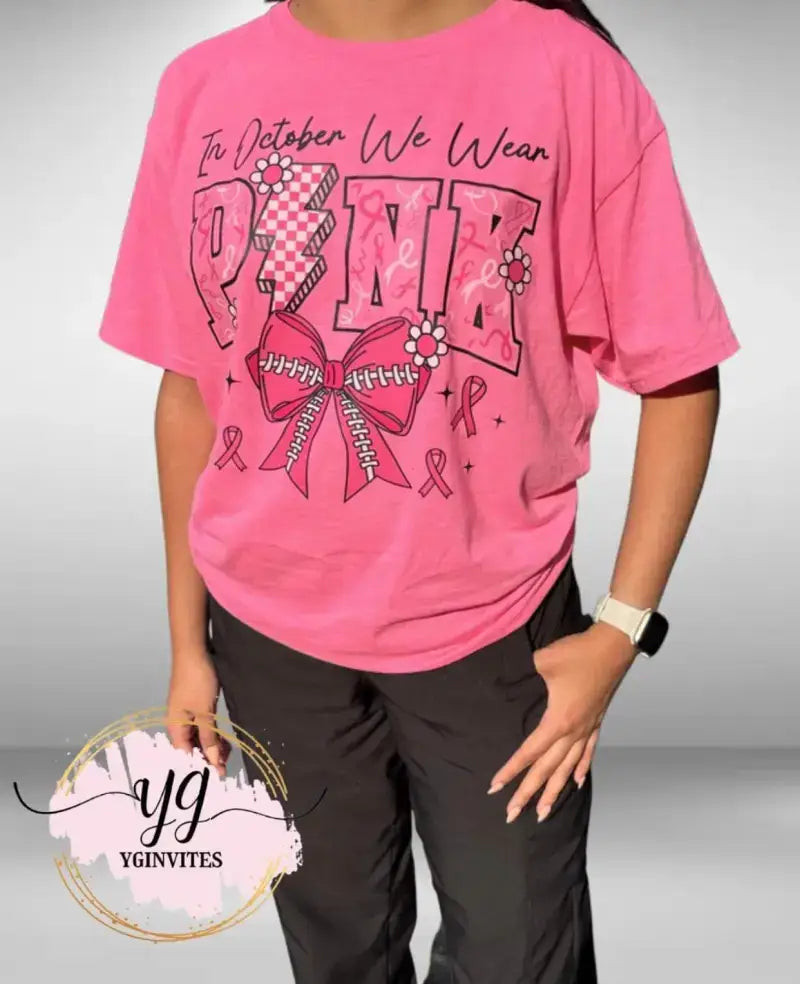 Pink breast cancer awareness t-shirt featuring ’PINK’ text and ribbon designs.