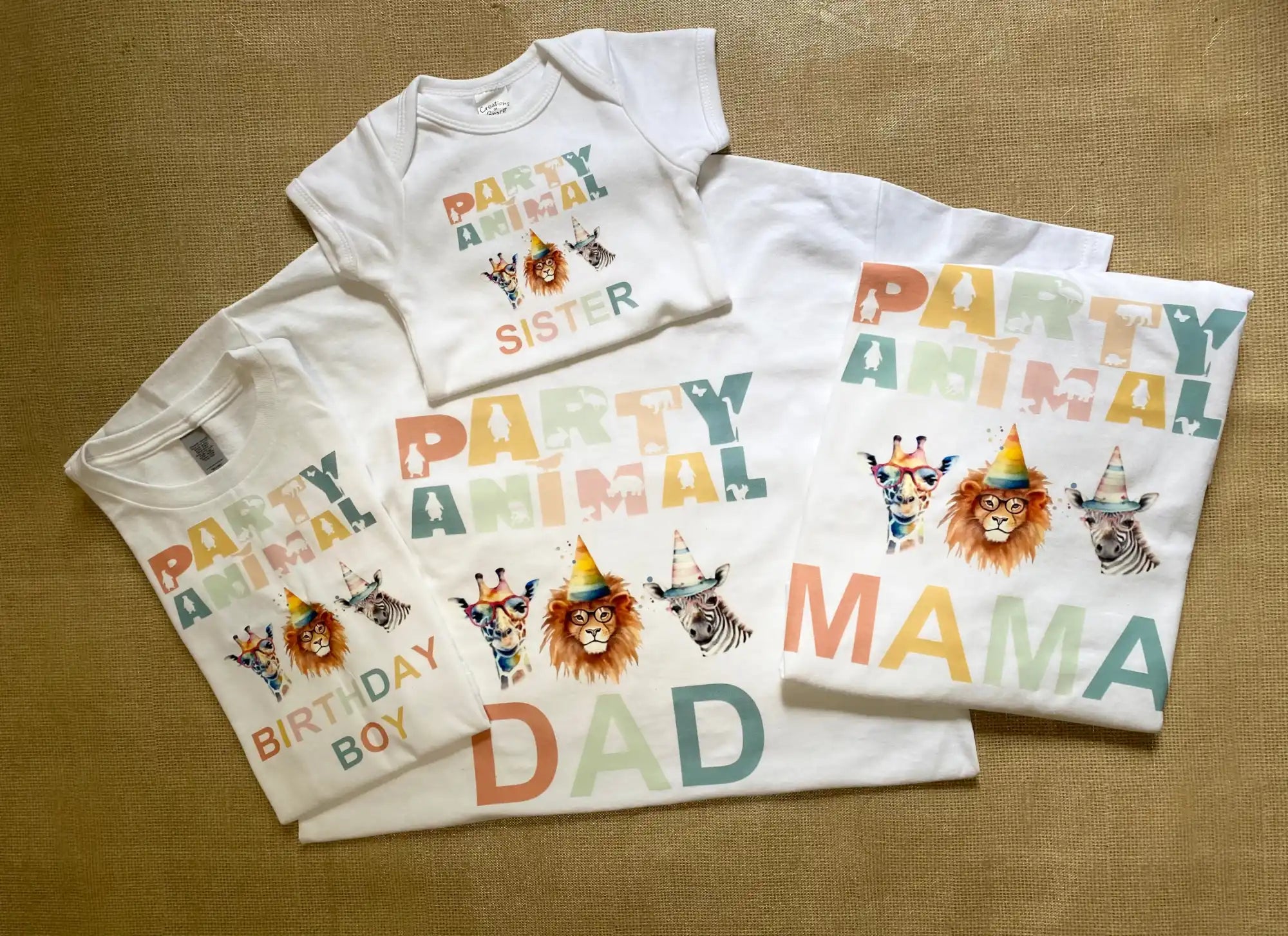 Set of matching white t-shirts with colorful ’Party Animal’ text and animal designs.