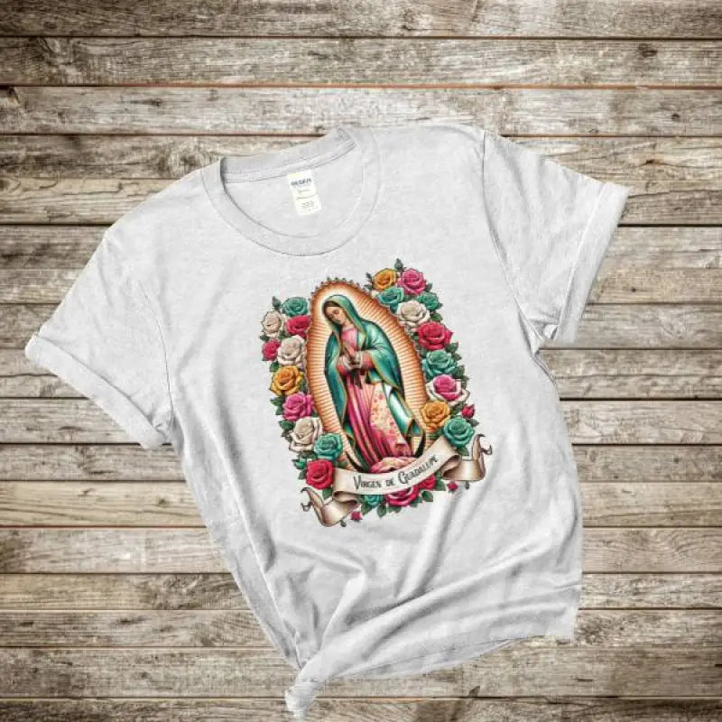 White t-shirt featuring Our Lady of Guadalupe artwork surrounded by colorful roses.